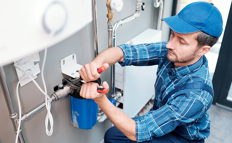Plumbing technician fixing pipes
